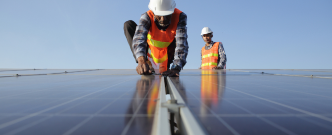 Workers Performing Maintenance On Solar Panels